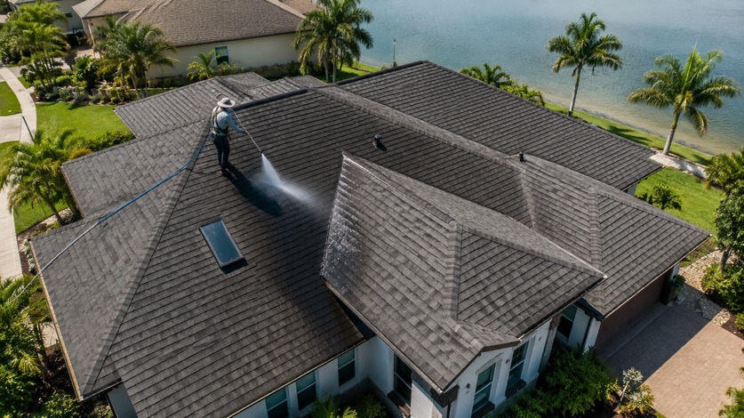 A SurfCoast crew treating a waterfront home's roof in St. Johns County